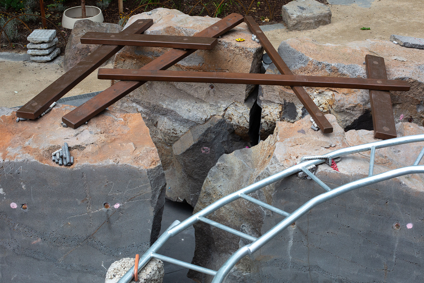 To lend a feeling of precariousness to the playground, creator Mike Hewson affixed to the boulders such materials as steel bars, pipes, rocks, and even hardened core samples left over from the project. (Image courtesy of Mike Hewson)